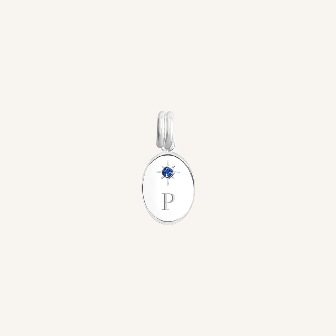 Silver pendant with a blue gemstone and letter 'P' on a white background