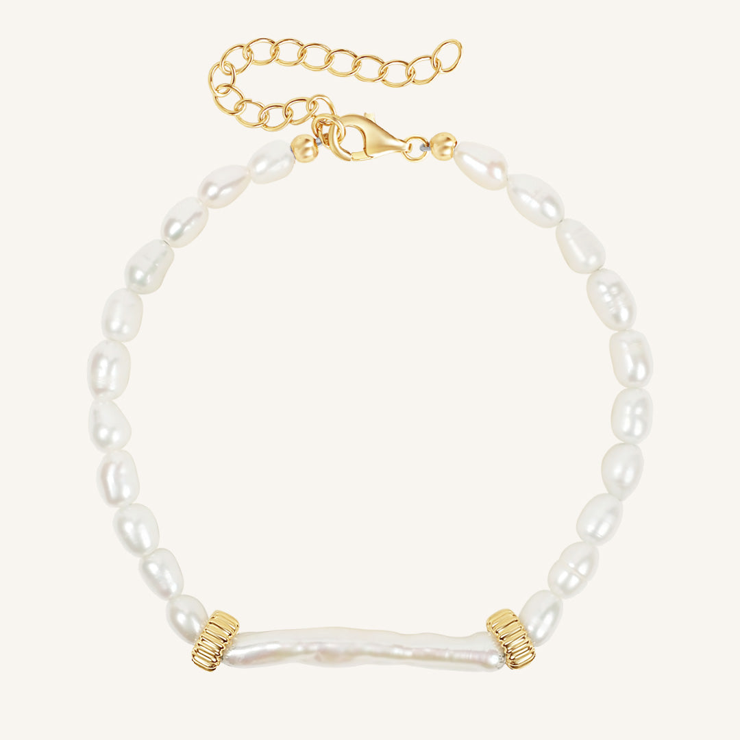 Pearl bracelet with gold accents on a white background