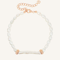 Pearl bracelet with rose gold accents on a white background