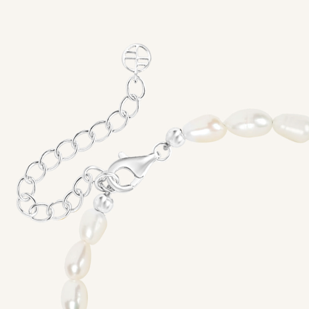 Pearl bracelet with silver clasp on a white background