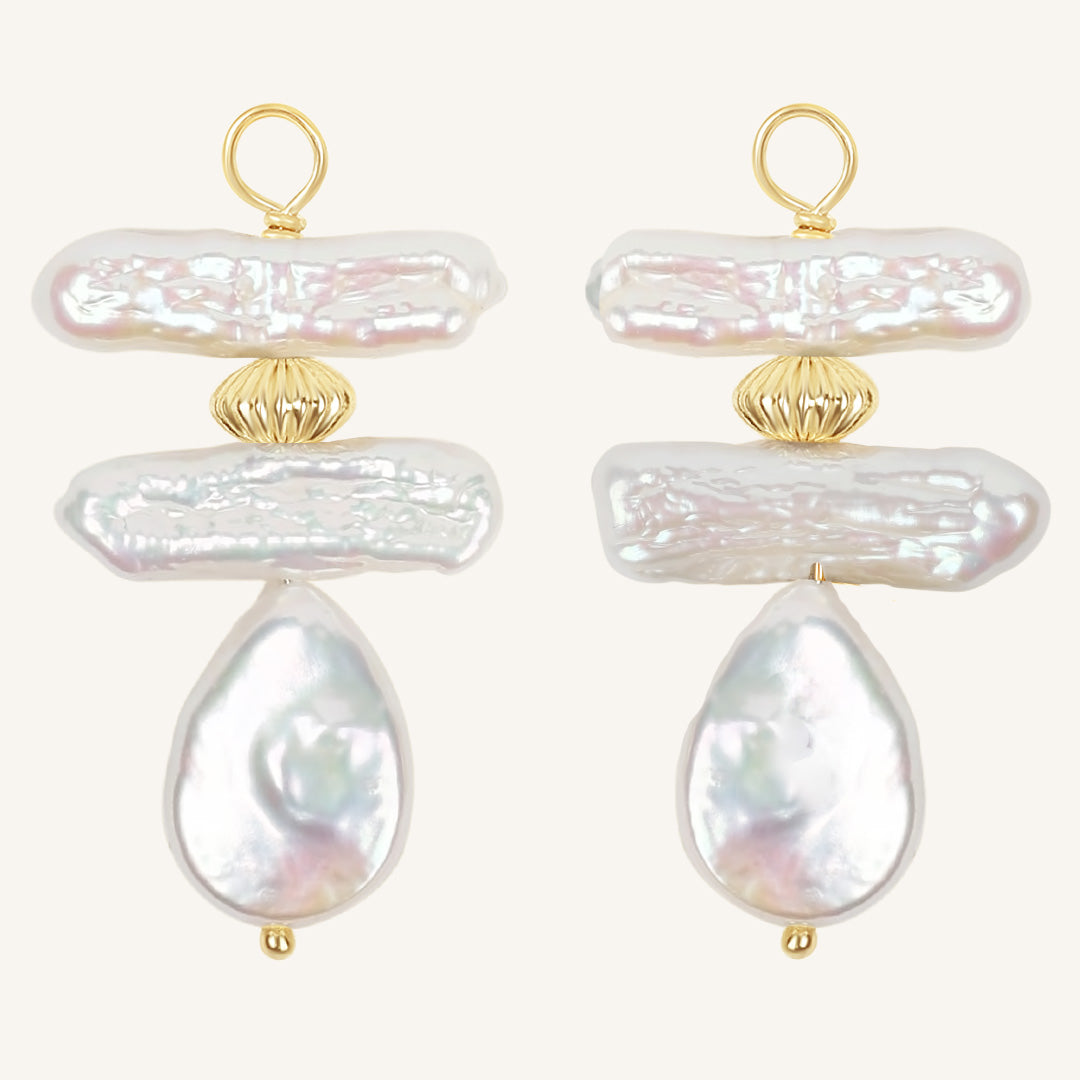 Pair of pearl hoop charms with gold accents on a white background