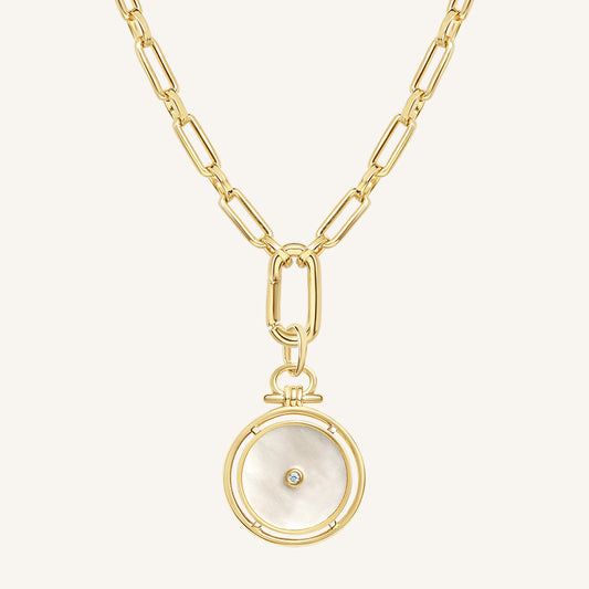 Gold necklace with a circular pendant on a white background