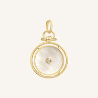 Gold pendant with a circular design and central gemstone on a light beige background