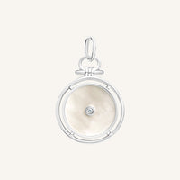 Silver pendant with a circular design and central gemstone on a white background