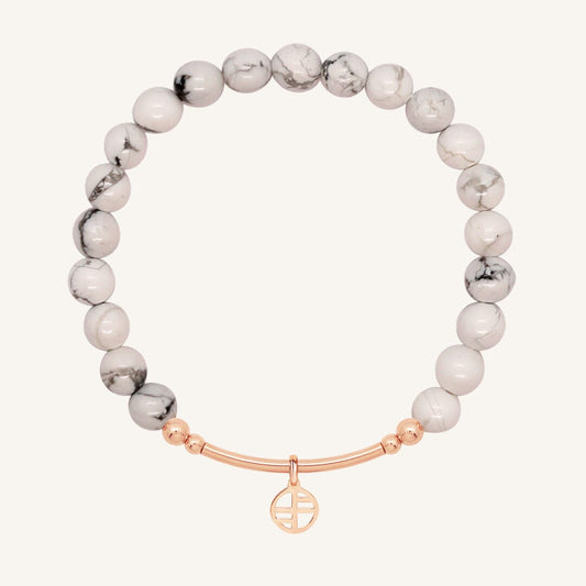 White beaded bracelet with a rose gold clasp on a white background