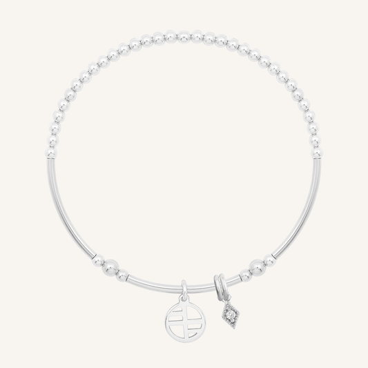 A silver-tone charm bracelet with a petite diamond charm and a stretchy bead chain.