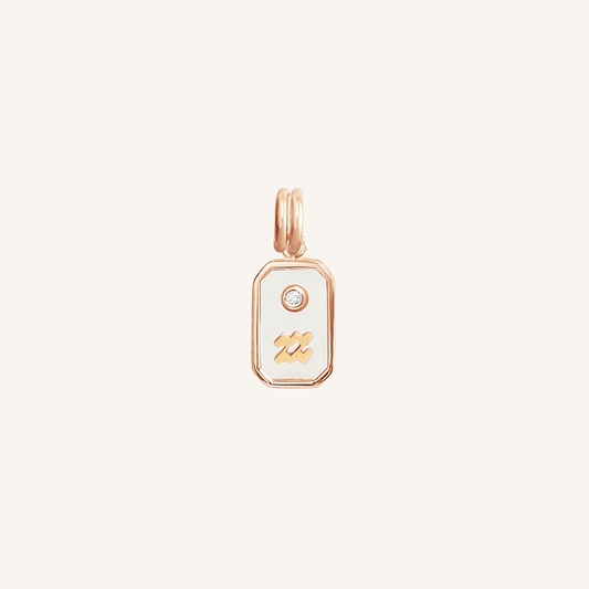 A rose gold rectangular shaped charm with the Aquarius zodiac symbol on it, designed with an iridescent finish.
