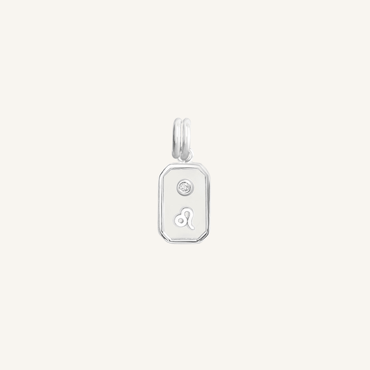 A silver rectangular shaped charm with the Leo zodiac symbol on it, designed with an iridescent finish.