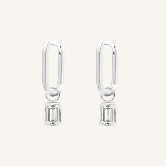 A rectangular pair of hoop charms with cubic zirconias attached to hoops