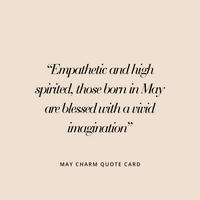 A gold charm with a green cubic zirconia, resembling a May birthstone.