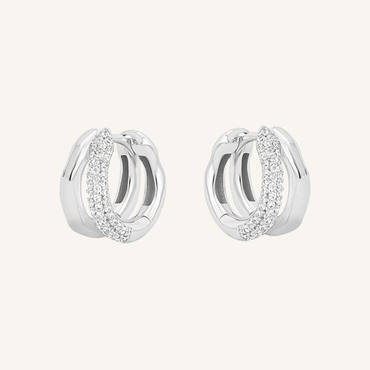 A pair of coloured hoop earrings with a huggie design, featuring a layered look.