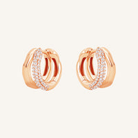 A pair of gold-colored hoop earrings with a huggie design, featuring a layered look.