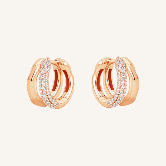 A pair of gold-colored hoop earrings with a huggie design, featuring a layered look.