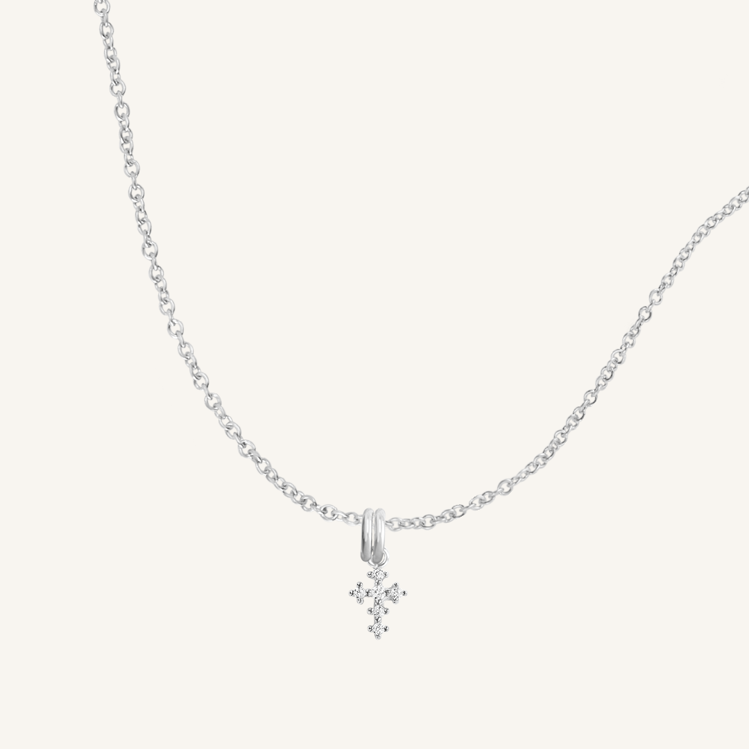 A silver-tone Nurture Cross Charm Pendant Necklace with a vintage cross shape on a chain.