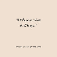 A gold-colored charm in the shape Tasmania 