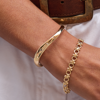 silver chain bracelet inspired by Eiffel tower on plain background