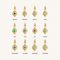 Gold necklace with a small pendant on a light beige background