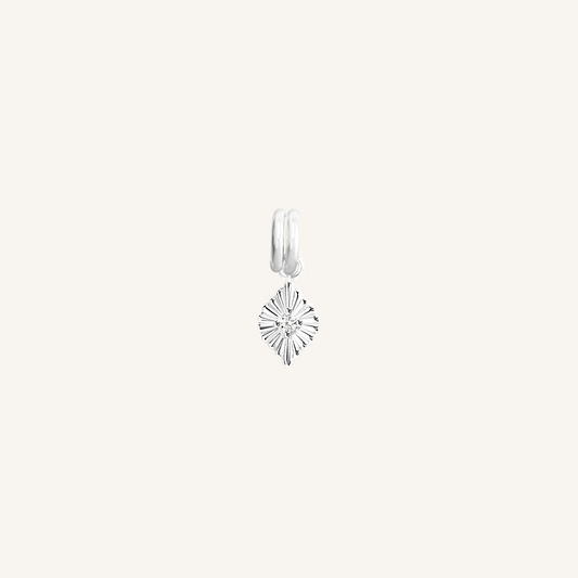 A silver birthstone charm with a white cubic zirconia representing the month of April.