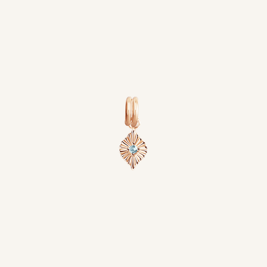A rose birthstone charm with a blue cubic zirconia representing the month of March.