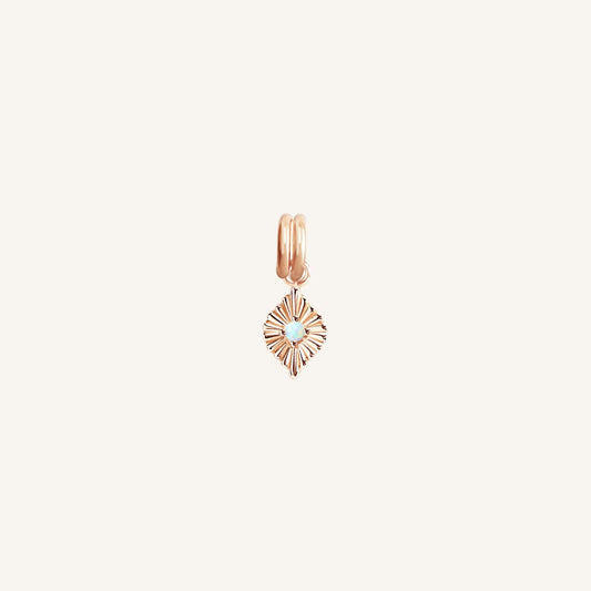 A rose diamond shaped charm with a faux opal in the centre, designed to be attached to a bracelet or necklace 