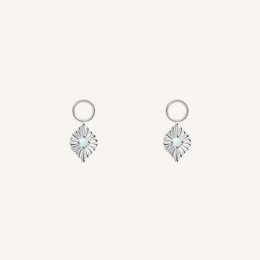 A pair of silver diamond shaped hoop charms featuring a faux opal
