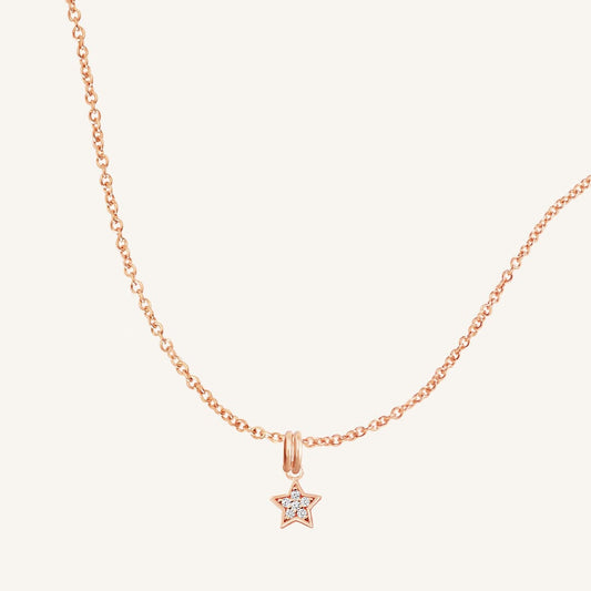 A rose gold necklace featuring a star-shaped charm pendant with cubic zirconias in the centre.