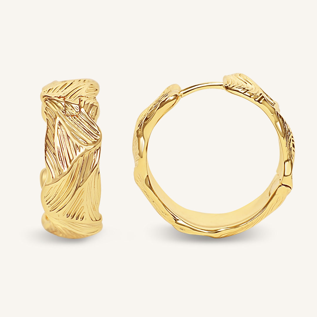 Gold hoop earrings on a white background