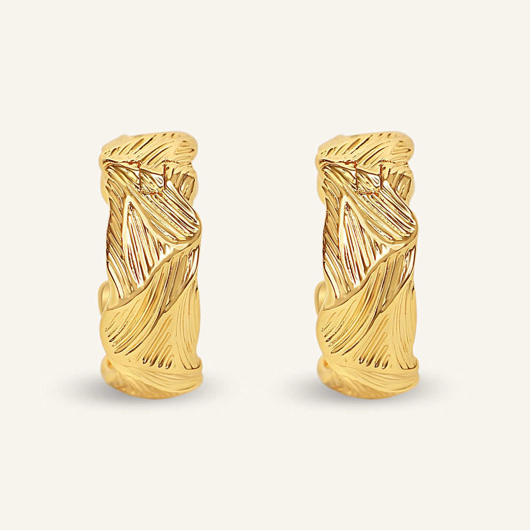 Pair of gold hoop earrings on a white background