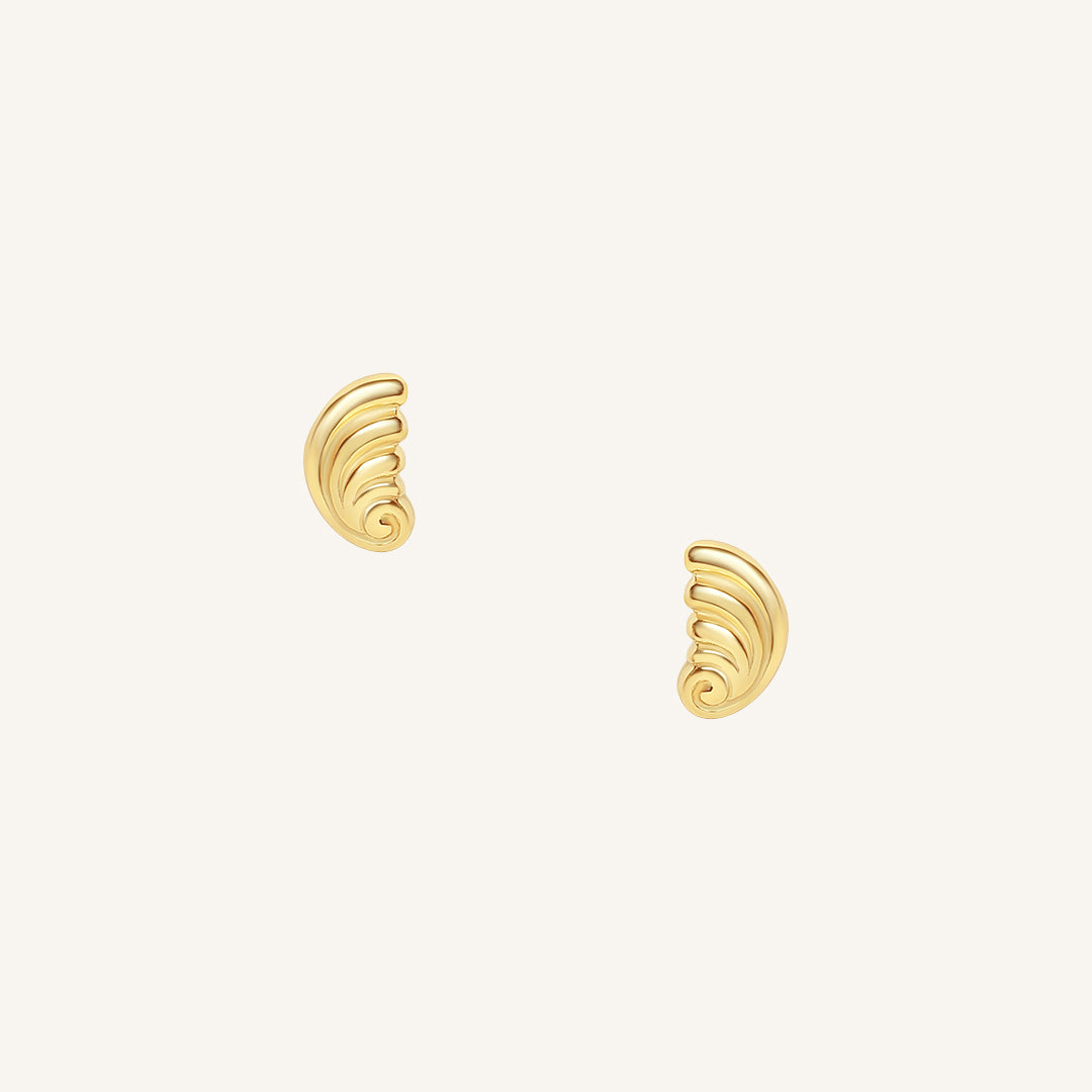 Pair of gold spiral earrings on a white background