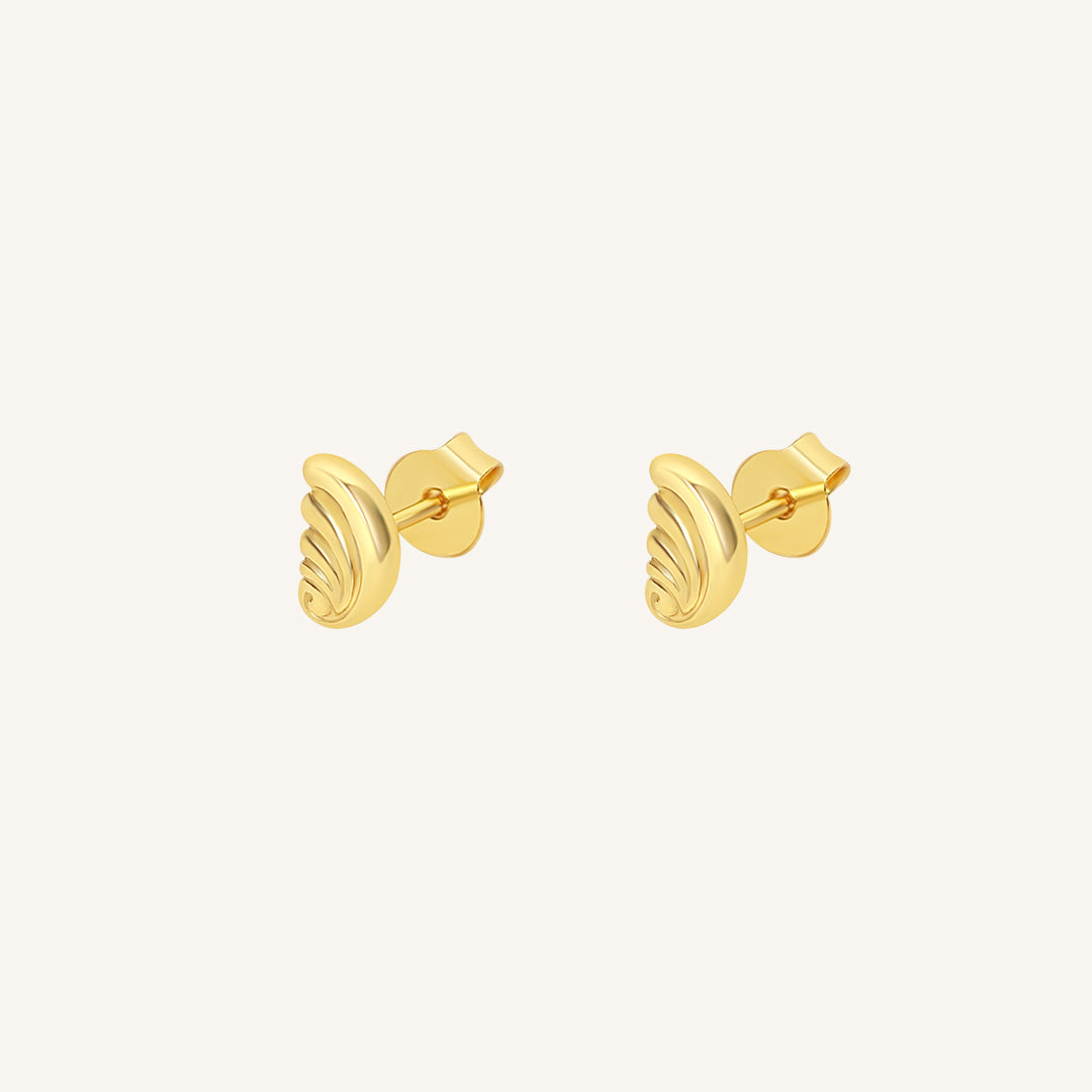 Gold earrings on a white background