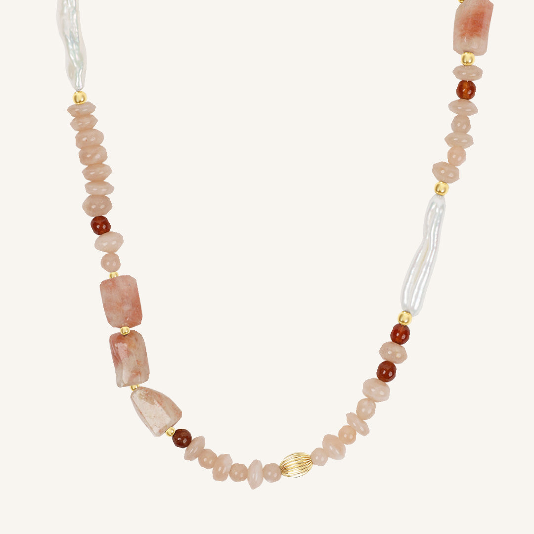 Necklace with pink and brown beads on a white background