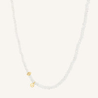 Necklace with small gold charms on a white background