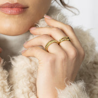 Silver ring with three bands on a white background