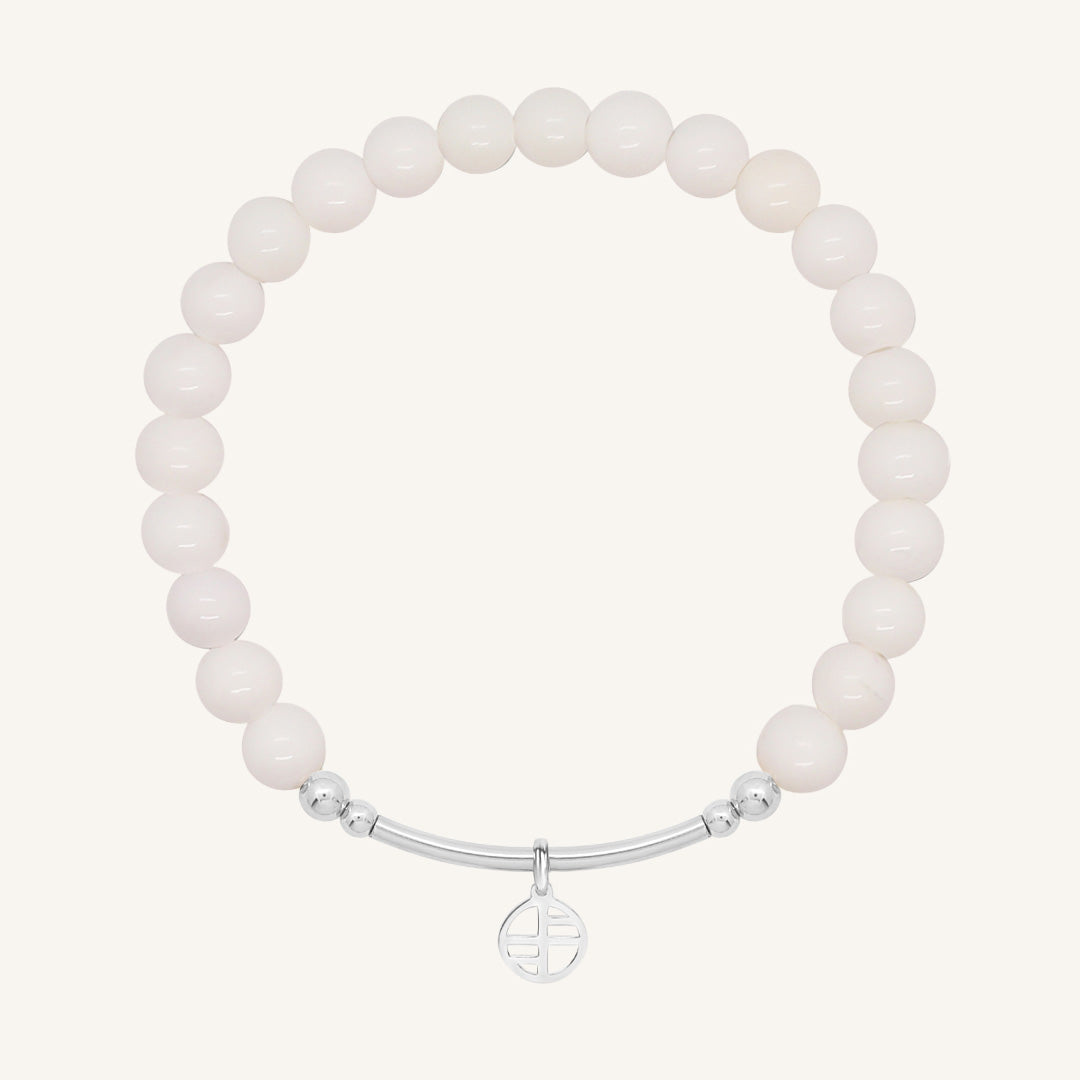 White beaded bracelet with a silver clasp on a white background