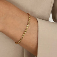 A gold-tone rope bracelet with a extender chain.