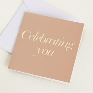 A greeting cards displayed on a neutral background, featuring designs such as 'celebrating you'.