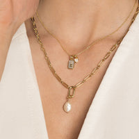 A single Keshi pearl charm with gold findings, displayed against a white background.