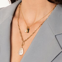 A single Keshi pearl charm with gold findings, displayed against a white background.