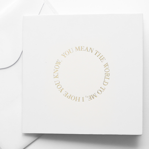 A greeting cards displayed on a neutral background, featuring designs such as 'you mean the world to me'.