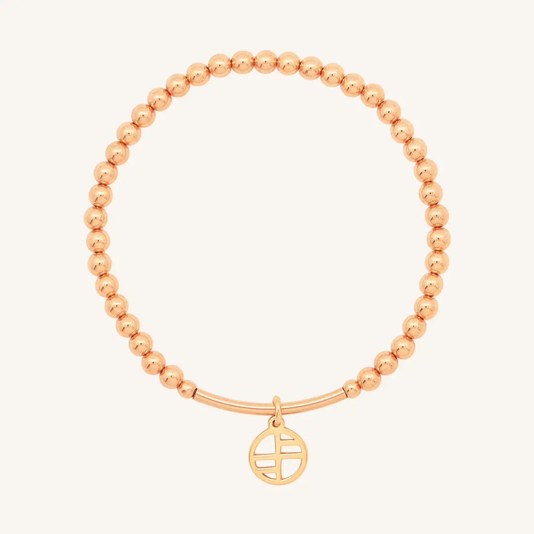 A rose-tone charm bracelet with 4mm beads and a charm pendant hanging in the center.