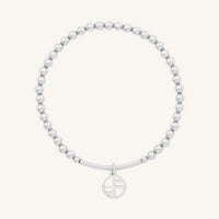 A silver-tone charm bracelet with 4mm beads and a charm pendant hanging in the center.