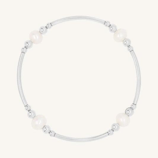 A silver bracelet with natural freshwater pearls, designed with a beaded pattern.