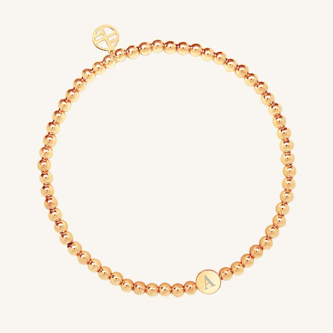 A rose bracelet with a beaded design and an engraveable bead