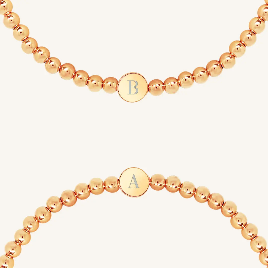 A rose bracelet with a beaded design and an engraveable bead, close up