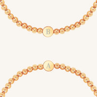 A silver bracelet with a beaded design and an engraveable bead