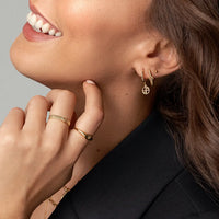 A pair of gold-tone drop earrings with the francesca logo